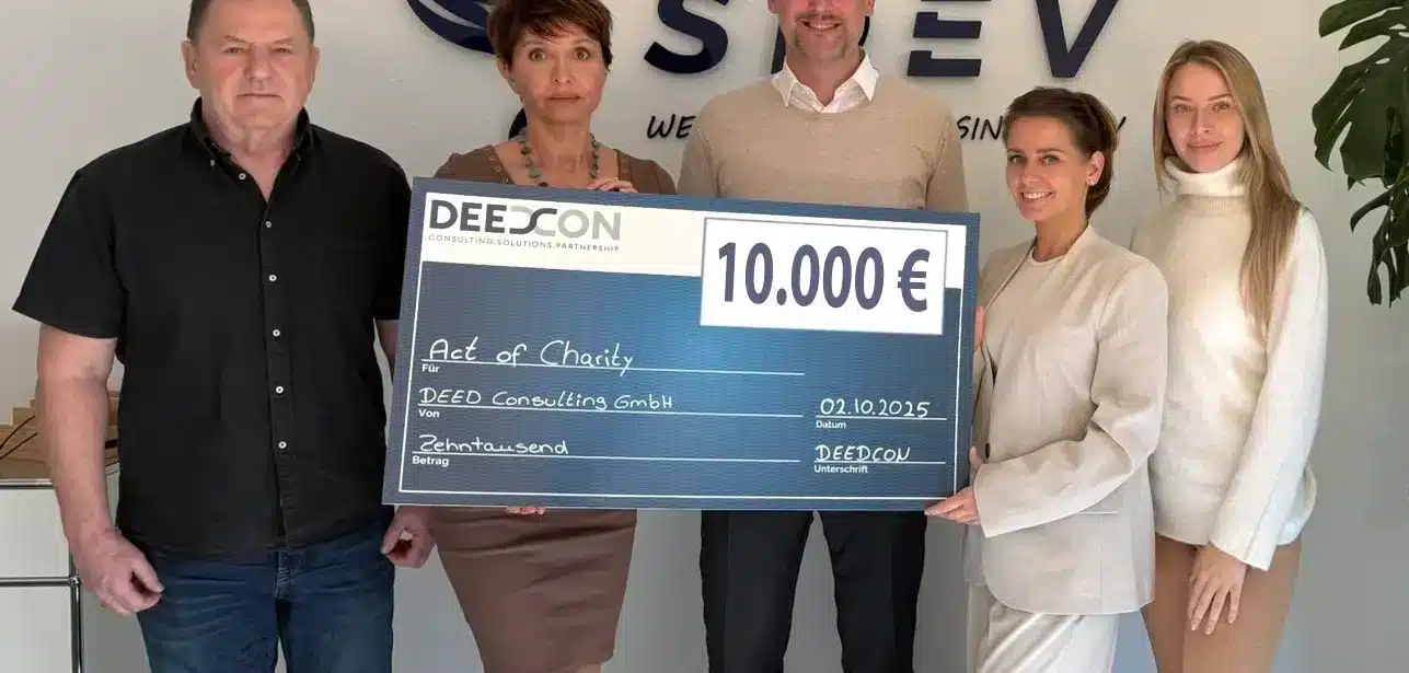 Group holds large check for 10,000 euros.